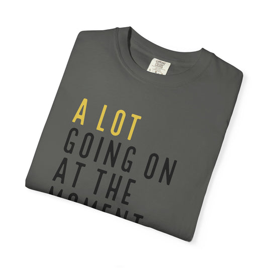Folded gray t-shirt with yellow and black text on a white background