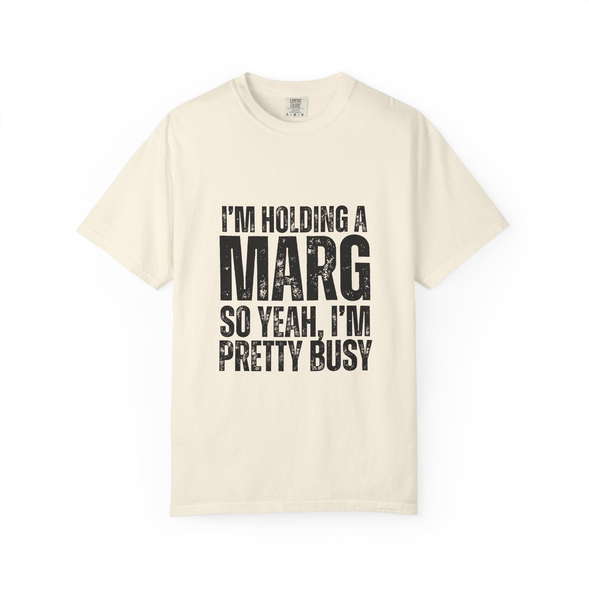 Beige t-shirt with black text reading 'I'm holding a marg so yeah, I'm pretty busy'