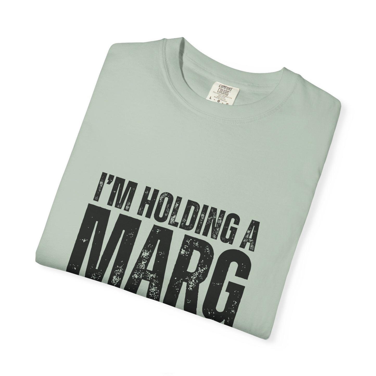 Folded light green t-shirt with 'I'm holding a marg' text 