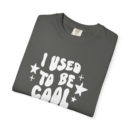 Folded gray t-shirt with white text 'I USED To Be Cool' on a white background