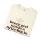 Folded t-shirt with text 'Every girl needs a little Rip in' on a white background