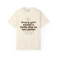 Beige t-shirt with text 'Every girl needs a little Rip in her jeans' on a white background