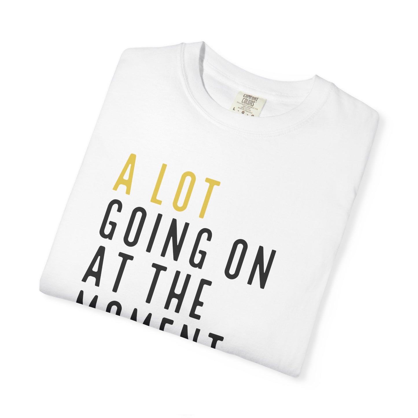 White t-shirt with yellow and black text on a white background