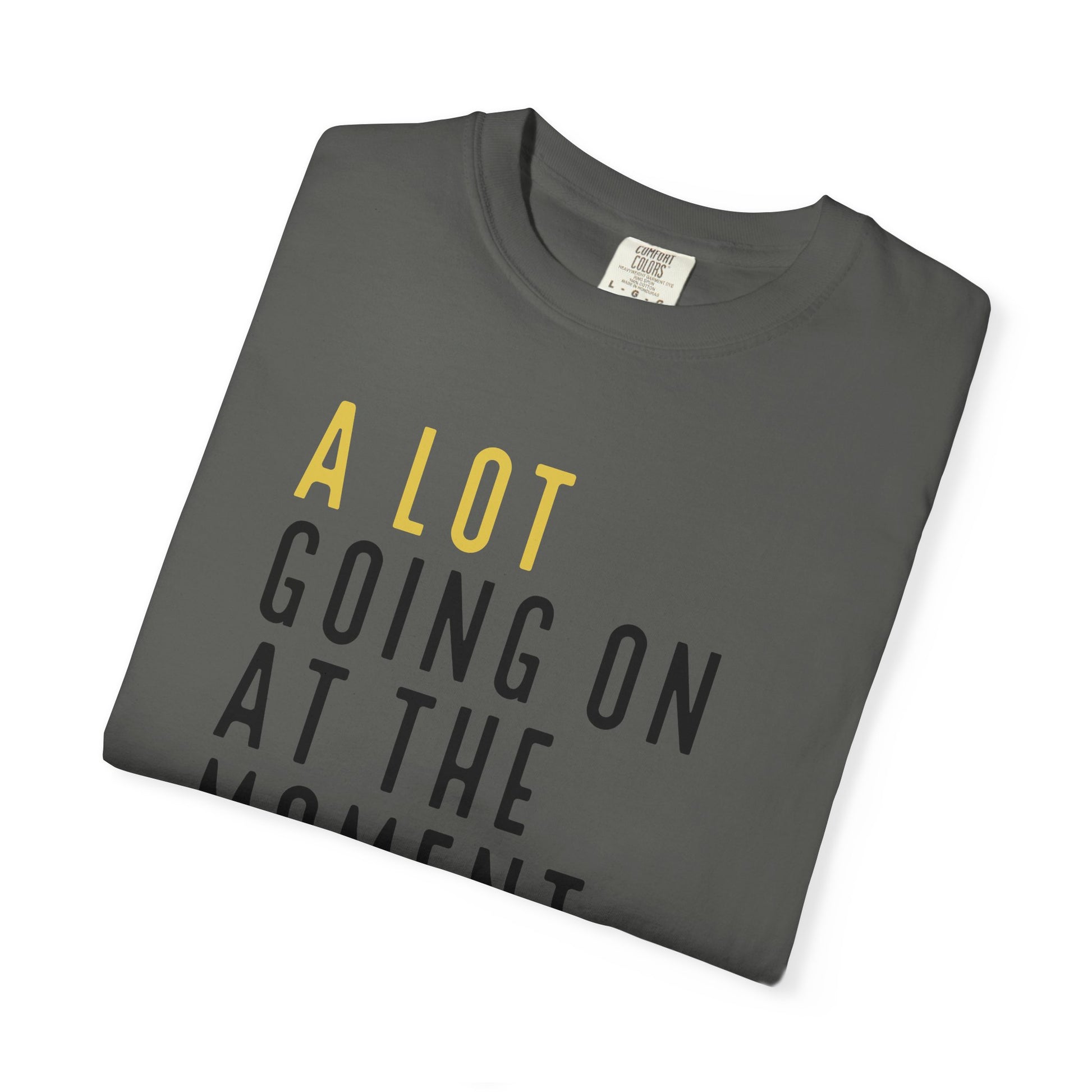 Folded gray t-shirt with yellow and black text on a white background
