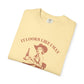 Folded yellow t-shirt with a graphic and text