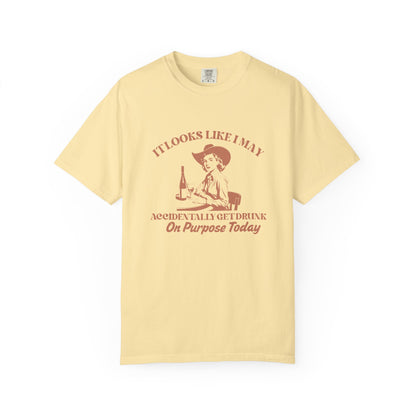 Yellow shirt with a cowgirl and text that says 'It looks like I may accidentally get drunk on purpose today' 