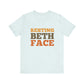 Light blue t-shirt with 'RESTING BETH FACE' text in orange and brown on a white background
