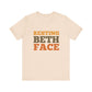 Beige t-shirt with 'RESTING BETH FACE' text in brown and black on a white background