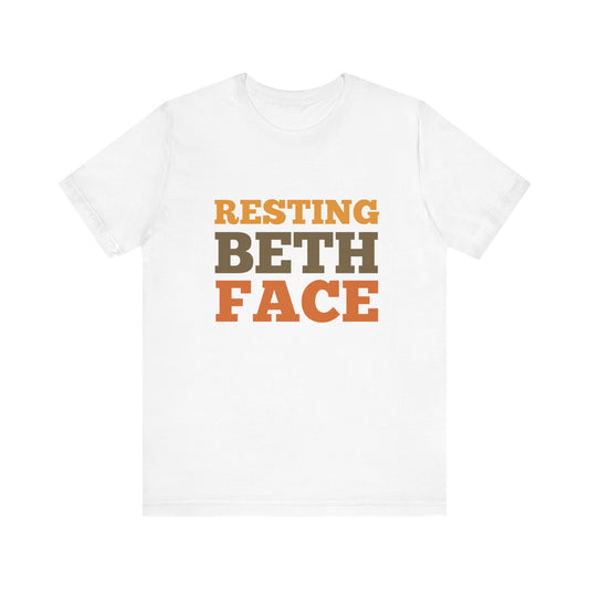 White t-shirt with 'RESTING BETH FACE' text in orange and brown on a white background
