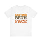 White t-shirt with 'RESTING BETH FACE' text in orange and brown on a white background