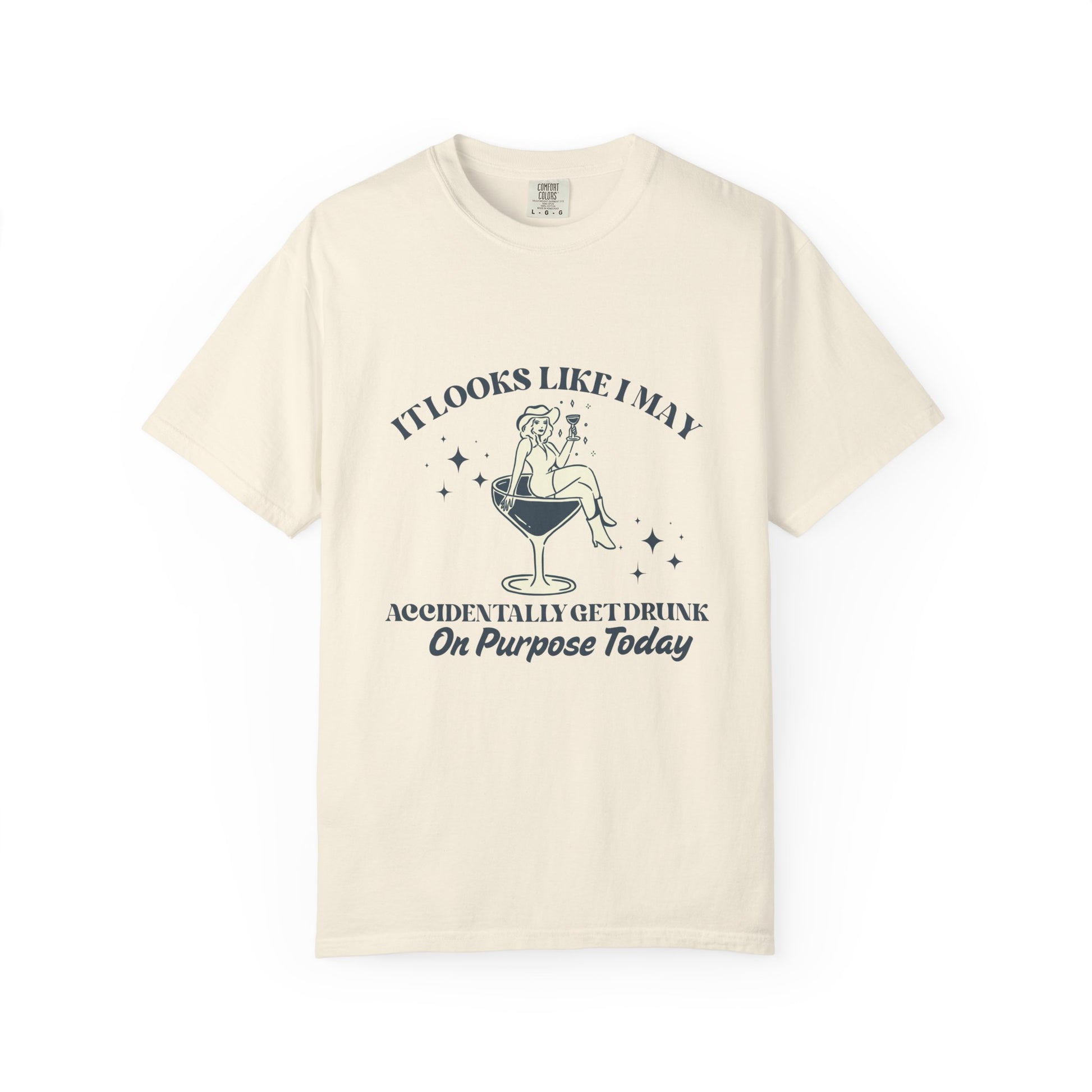 Cream shirt with 'It looks like I may accidentally get drunk on purpose today" and a lady in a cowboy hat sitting in a martini 