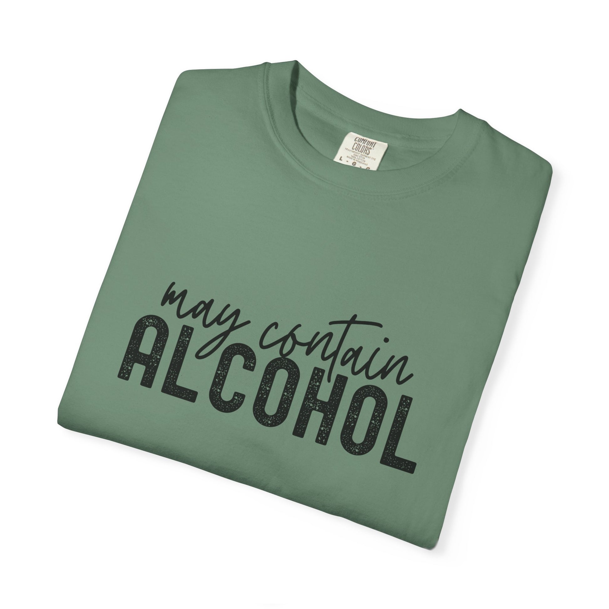 Folded green t-shirt with 'may contain ALCOHOL' text 