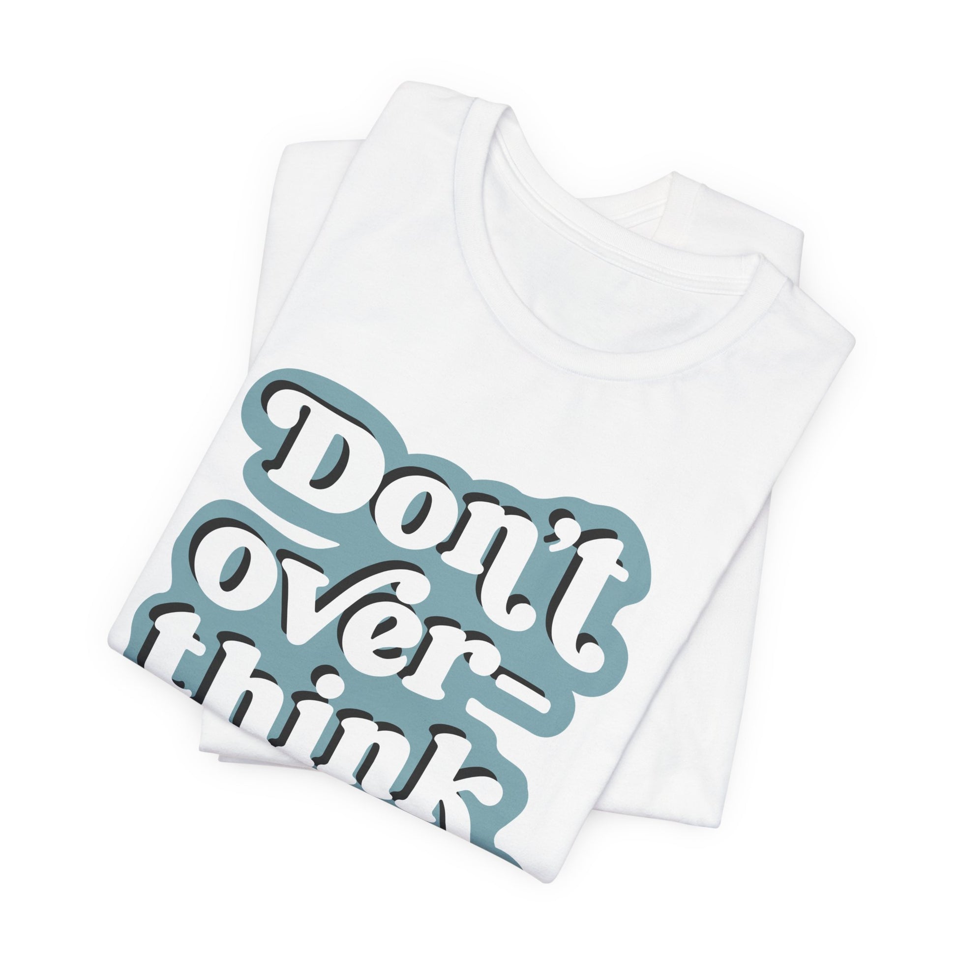 folded white tee with 'Don't over think' text on a white background