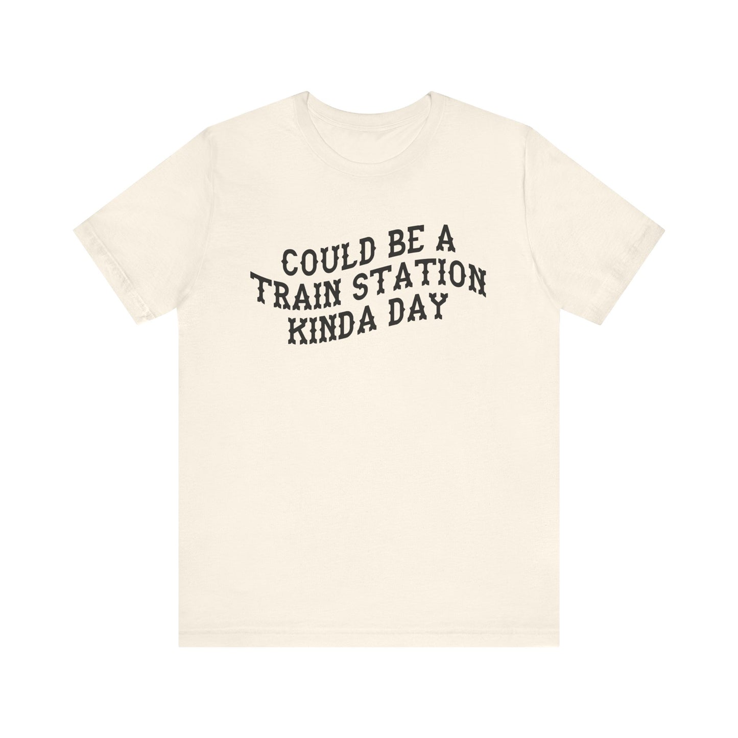 Beige t-shirt with 'could be a train station kinda day' in black text on a white background