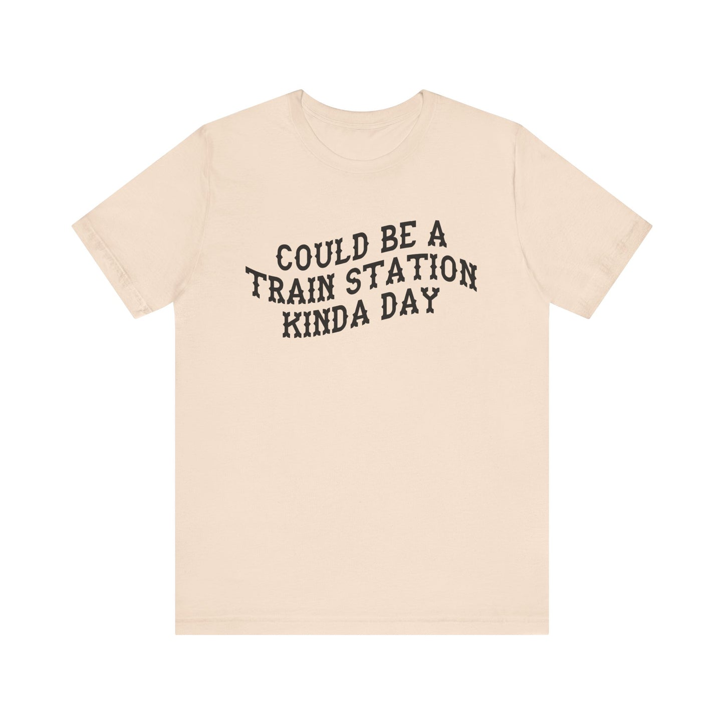 Beige t-shirt with 'could be a train station kinda day' in black text on a white background
