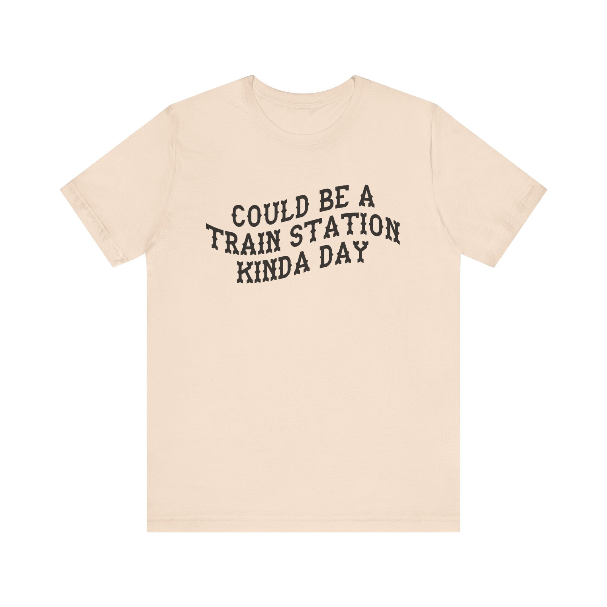 Beige t-shirt with 'could be a train station kinda day' in black text on a white background