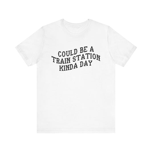 White t-shirt with 'could be a train station kinda day' inblack text on a white background